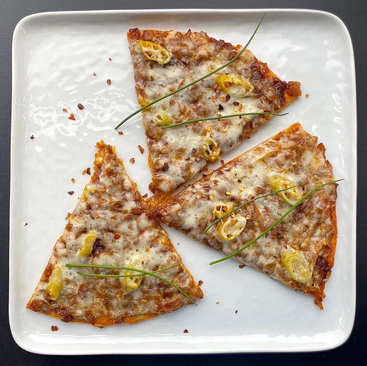 Three pizza slices served