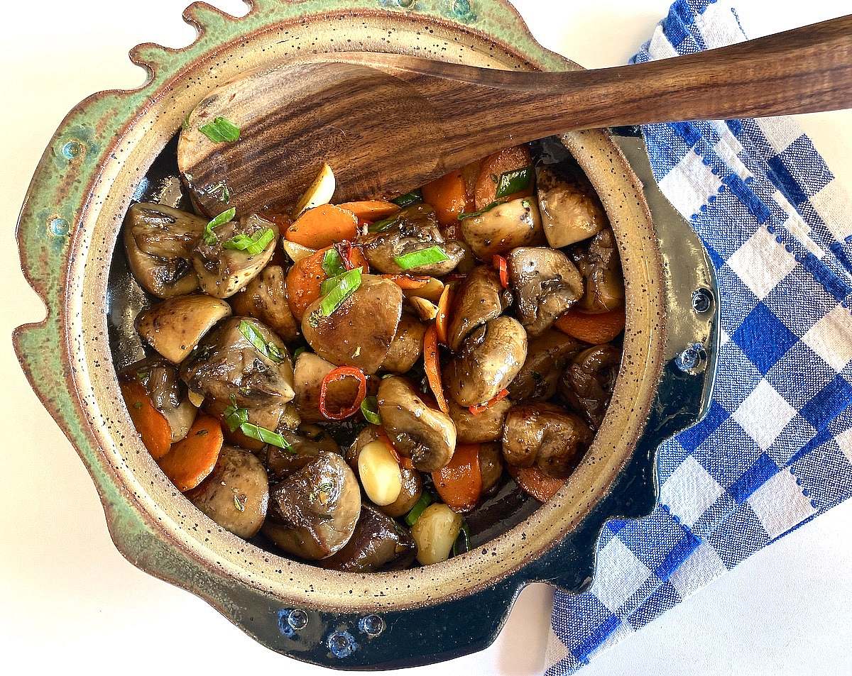 Mushroom dish in ceramic bowl with spoon