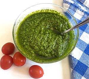 Pesto sauce in bowl with checkered napkin