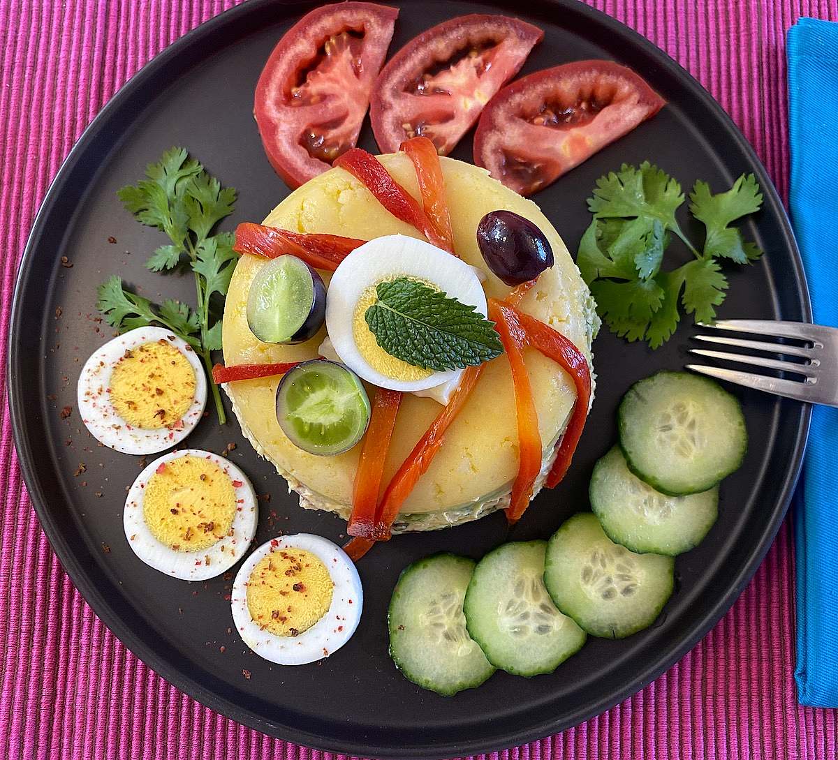 Causa serving with vegetables and egg