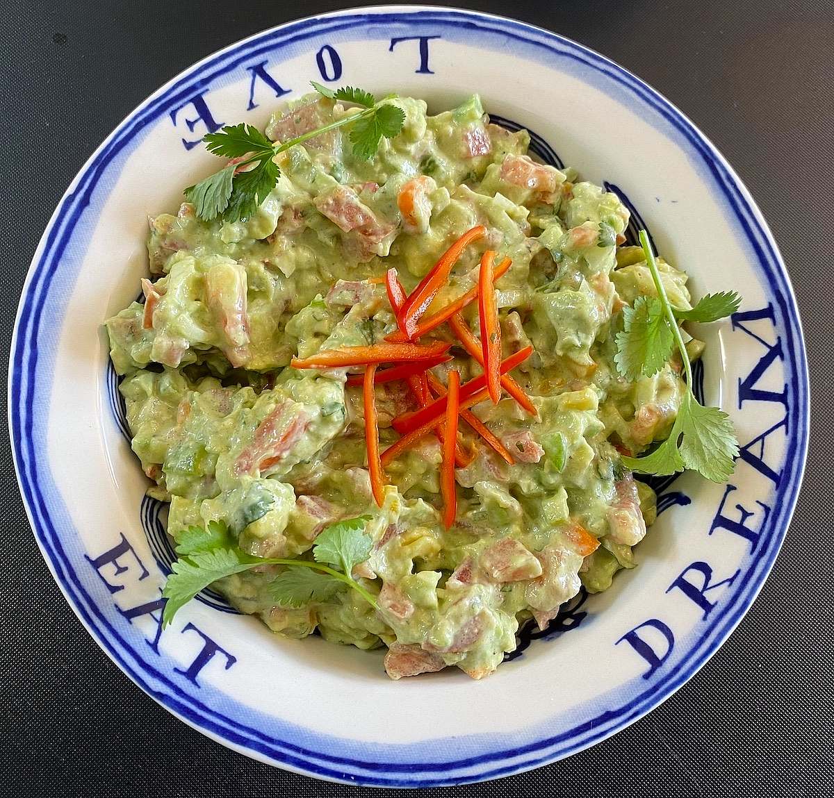 Guacamole served with red pepper garnish