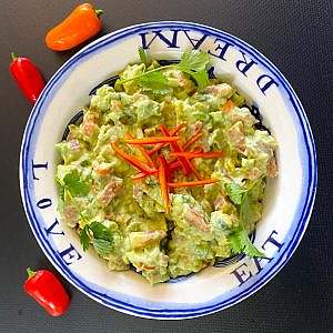 Guacamole serving with red peppers