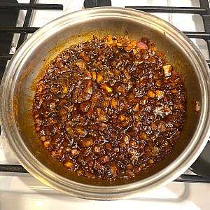 Caramelized onions with paprika in a pan, golden and glossy.