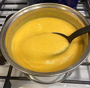 Freshly blended carrot parsnip potato soup in a pot, showing smooth and velvety texture before seasoning